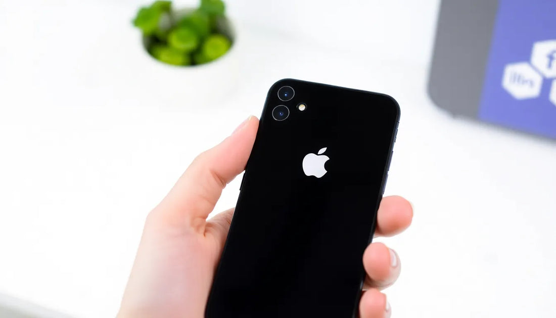 Close-up of a hand holding a black smartphone, signaling excitement for the upcoming iPhone 17